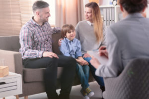 A family talks with a trained and licensed clinician to help resolve their issues instead of placing the child into foster care.