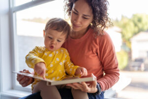 mother reading book with toddler 