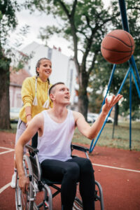 Disabled men playing basketball with friends