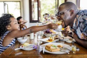 Man and child sharing food together